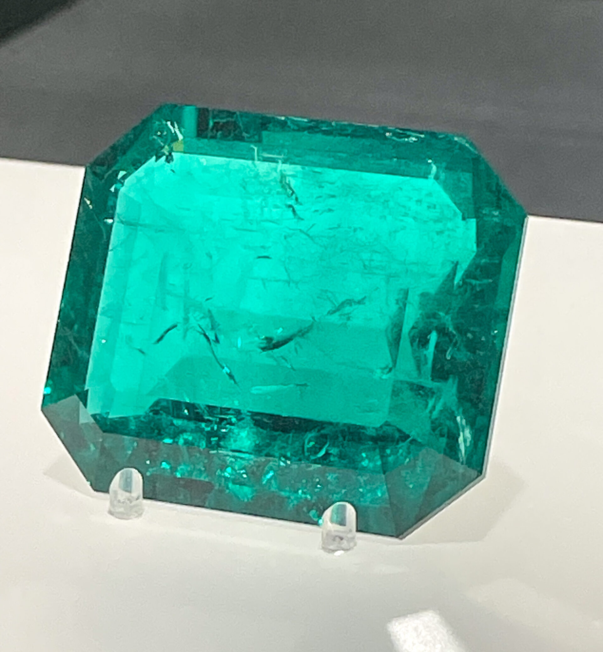 Large rectangular emerald stone on museum display stand 