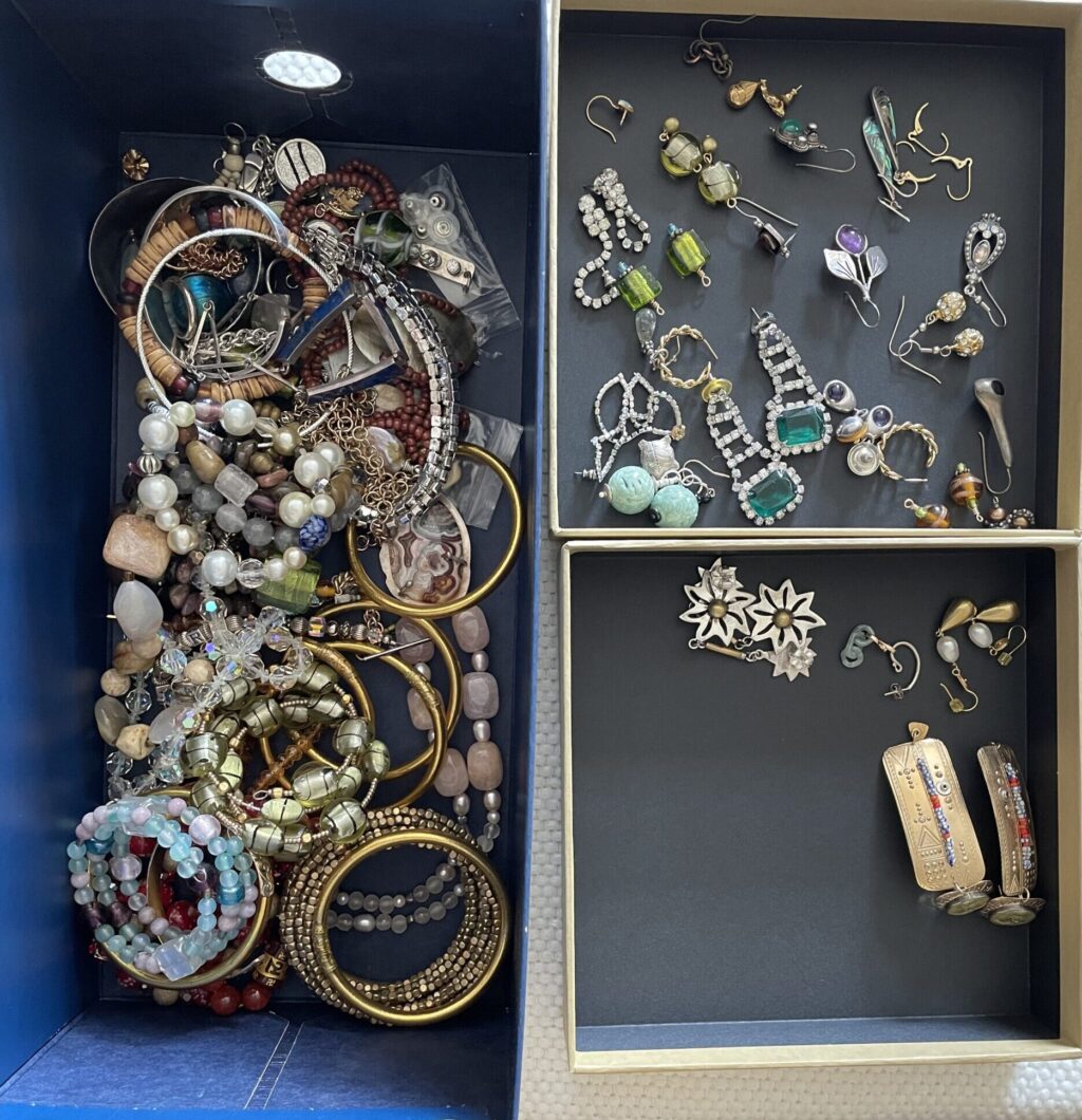 Disorganized jewelry before and after jewelry organization, showing how to organize your jewelry drawer by starting with moving earrings into pairs