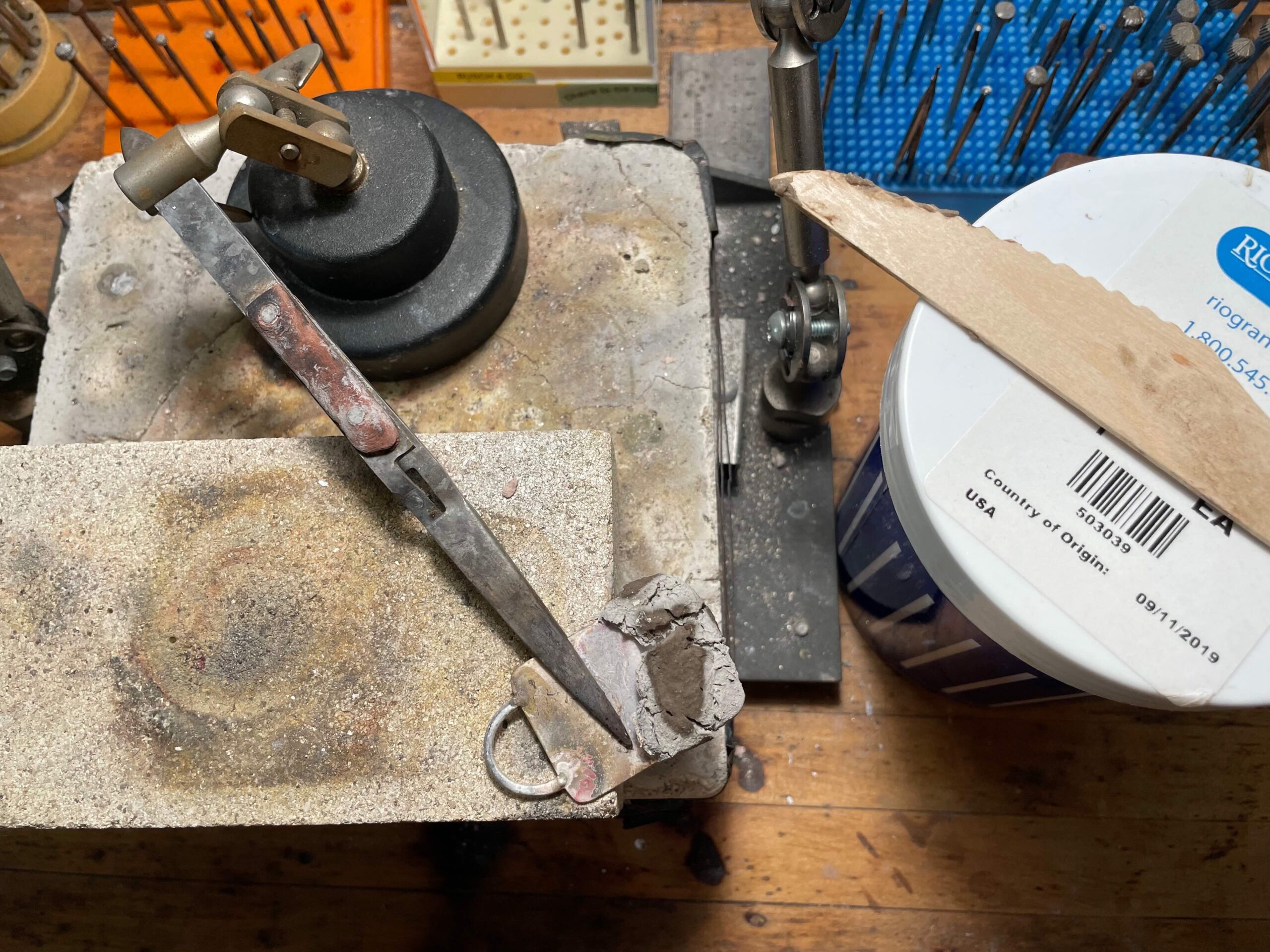 Keychain repair preparation on jeweler's bench