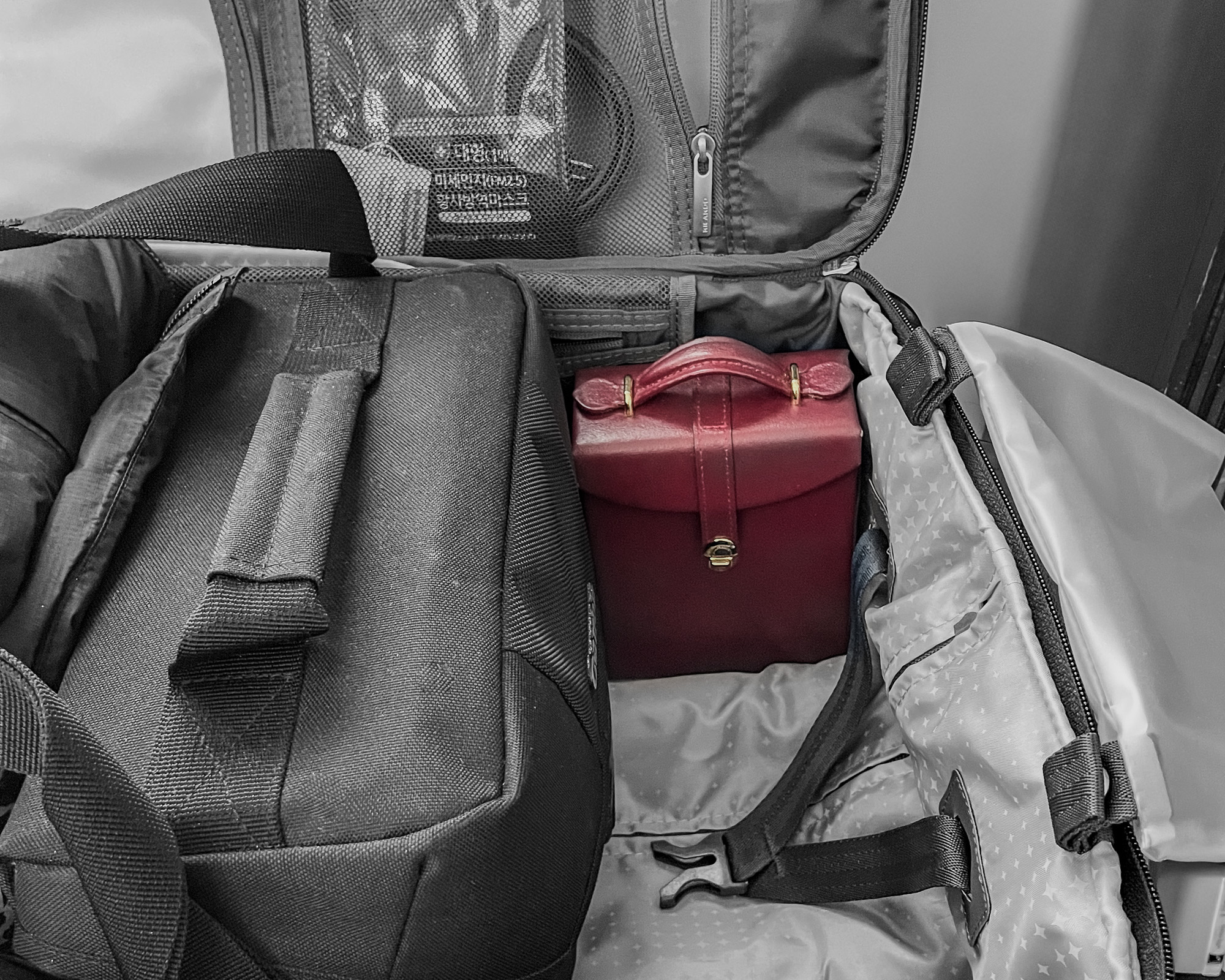 Red jewelry travel case in a carry on suitcase