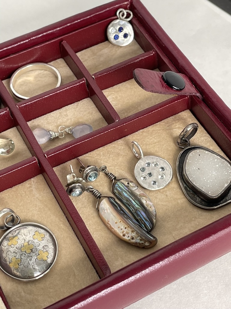Red jewelry box with handmade pendantss and earrings